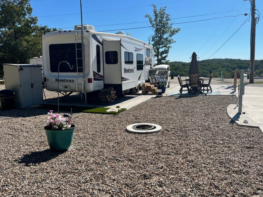 view of a back in rock site with a fire pit and tree view